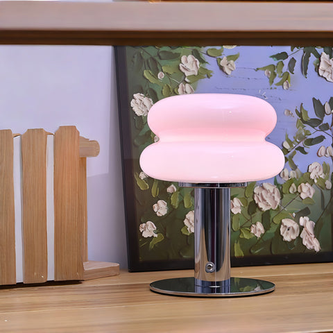 cream-style glass egg-tart lamp glowing with soft warm light from Gallery of Use