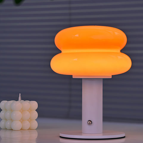 cream-style glass egg-tart lamp glowing with soft warm light from Gallery of Use