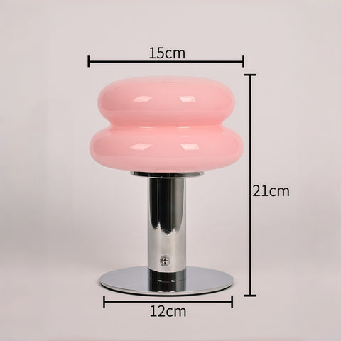 cream-style glass egg-tart lamp glowing with soft warm light from Gallery of Use