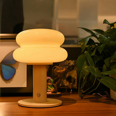 cream-style glass egg-tart lamp glowing with soft warm light from Gallery of Use
