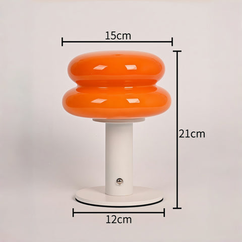 cream-style glass egg-tart lamp glowing with soft warm light from Gallery of Use