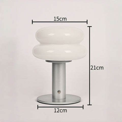 cream-style glass egg-tart lamp glowing with soft warm light from Gallery of Use